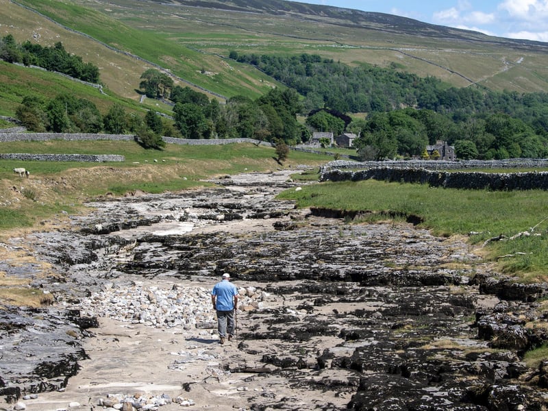 Local farmer Stewart Lund checks the welfare of his flock of sheep which graze by the River Skirfare in Littondale photographed for the Yorkshire Post by Tony Johnson.
