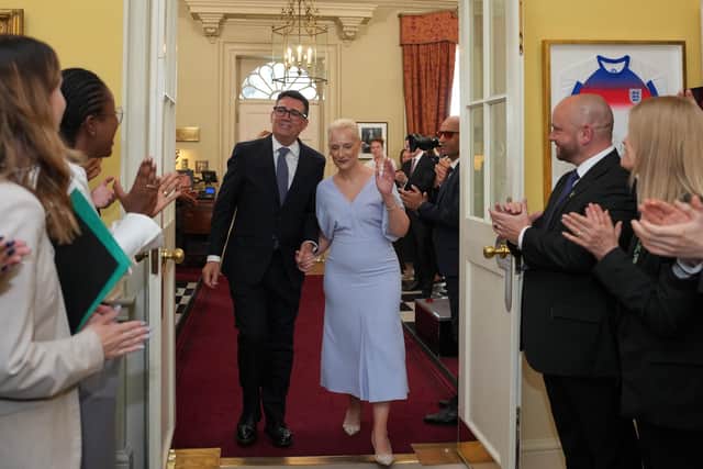 New Prime Minister Andy Burnham and his wife Marie-France van Heel are greeted by staff as he walks into 10 Downing Street, London, for the first time as Prime Minister. Picture date: Monday July 20, 2026. Kin Cheung/PA Wire