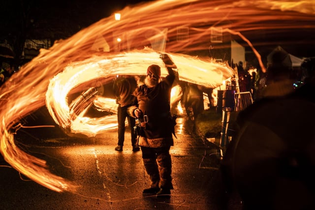 A performer swings a fireball during the Flamborough Fire Festival, a Viking themed parade in aid of charities and local community groups, held on New Year's Eve in Flamborough near Bridlington, Yorkshire. Picture date: Saturday December 31, 2022.