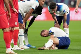 England's Harry Kane holds his ankle. England captain Harry Kane is set to have a scan on his right ankle before Friday’s World Cup match against the United States. The 29-year-old provided two assists in the Three Lions’ 6-2 win against Iran as they opened the tournament with a bang on Monday at the Khalifa International Stadium. Picture: Martin Rickett/PA Wire.