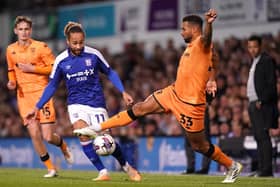 LEARNING FAST: Hull City's Cyrus Christie battles for the ball against Ipswich Town's Marcus Harness (left) during the Tigers' 3-0 defeat at Portman Road on Tuesday. Picture: John Walton/PA