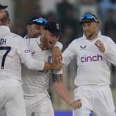 MAGICAL MOMENT: Captain Ben Stokes (centre) and Joe Root (right) celebrate after winning the first Test against Pakistan with the rest of the England team in Rawalpindi. Picture: AP Photo/Anjum Naveed
