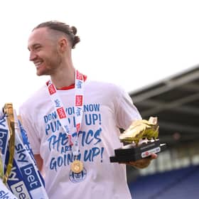 SHREWSBURY, ENGLAND - APRIL 30: Will Keane of Wigan Athletic celebrates with the League One trophy and Golden Boot award after their sides victory and promotion to the Championship during the Sky Bet League One match between Shrewsbury Town and Wigan Athletic at Montgomery Waters Meadow on April 30, 2022 in Shrewsbury, England. (Photo by Charlotte Tattersall/Getty Images)