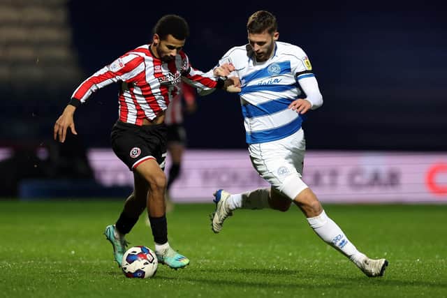 ALL-SQUARE: Sheffield United's Iliman Ndiaye and Queens Park Rangers' Sam Field battle for the ball at Loftus Road during last night's Championship draw 
 Steven Paston/PA
