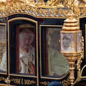 King Charles III and Queen Camilla are carried in the Diamond Jubilee State Coach as the King's Procession passes along The Mall to their coronation ceremony. PIC: Lucy North/PA Wire