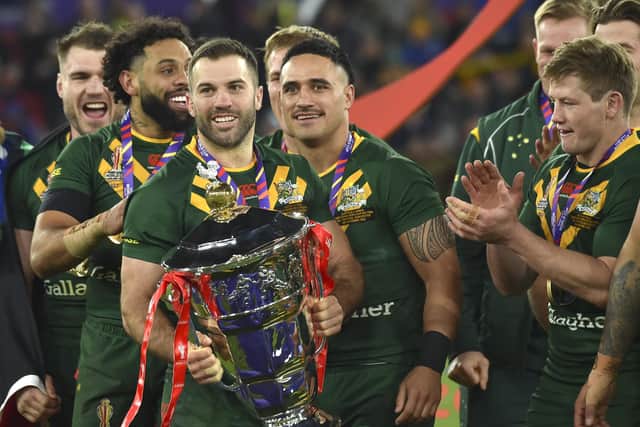 Australia's James Tedesco, centre, holds the trophy after winning the World Cup. (AP Photo/Rui Vieira)