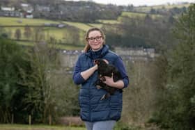 Rebecca Robson with a copper black maran cross with black bantams heritage breed chicken in Holmfirth