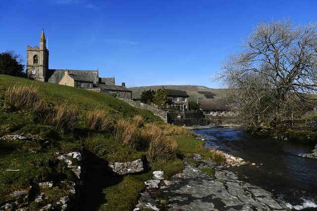 Gayle Beck runs through Hawes, with a view of St Matgaret's Church in the Yorkshire Dales.