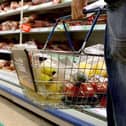 A person holding a shopping basket in a supermarket. PIC: Julien Behal/PA Wire