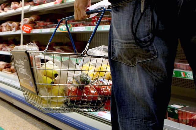 A person holding a shopping basket in a supermarket. PIC: Julien Behal/PA Wire