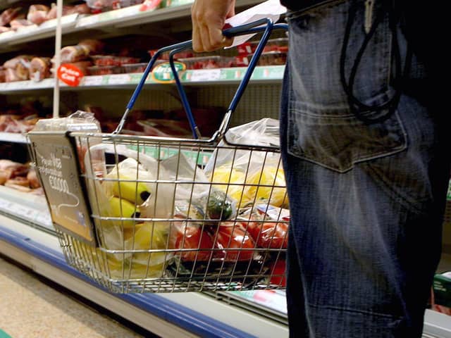 A person holding a shopping basket in a supermarket. PIC: Julien Behal/PA Wire