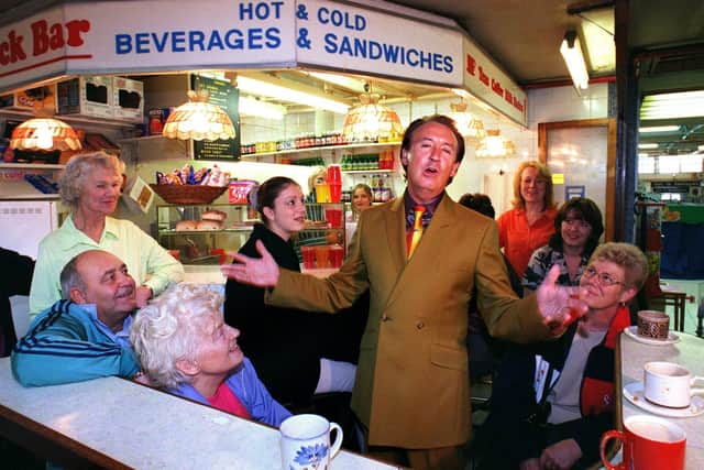 Sixties popstar Tony Christie singing in Sheffield's fish and meat market in Exchange street for a music video
