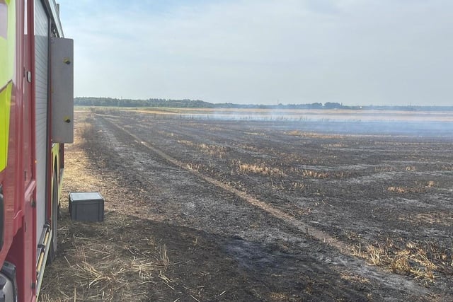 Cheshire Fire and Rescue Service firefighters attending to a grass fire in Rixton, Warrington. Britons have been melting on the hottest UK day on record as temperatures topped 40C.