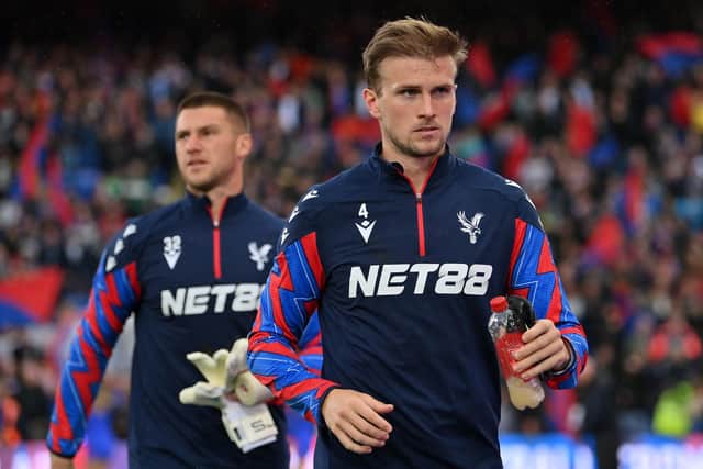 LONDON, ENGLAND - AUGUST 24: Rob Holding of Crystal Palace (right) and team-mate Sam Johnstone (left) look on prior to the Premier League match between Crystal Palace FC and West Ham United FC at Selhurst Park on August 24, 2024 in London, England. (Photo by Patrick Khachfe/Getty Images)