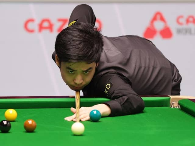 Si Jiahui of China plays a shot against Mark Williams of Wales in their first round match during day four of the Cazoo World Snooker Championship 2024 at Crucible Theatre. (Photo by George Wood/Getty Images)