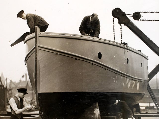 Firemen of the Leeds Auxiliary Fire Service (AFS) at work on a fire-float which is a converted lifeboat from the liner 'Berengaria' in Leeds during the Second World War in 1939.