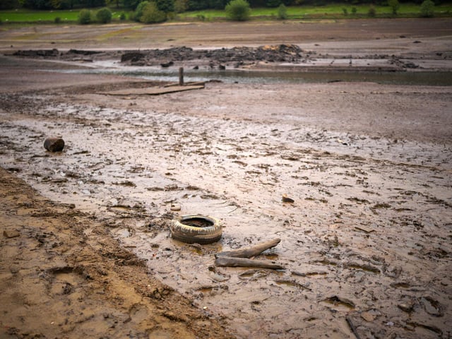 People inspect the ruins of Derwent Village, flooded in the 1940s to provide drinking water for the East Midlands and Sheffield,  become exposed due to the low water level at Ladybower Reservoir and drought conditions. (Photo by Christopher Furlong/Getty Images)