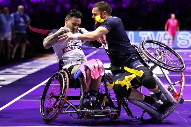 Lewis King of England is tackled by Julien Penella of France during the Wheelchair Rugby League World Cup Final match between France and England at Manchester Central on November 18, 2022 in Manchester, England. (Photo by Jan Kruger/Getty Images for RLWC)