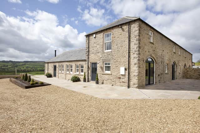 The farmhouse and two barns are now luxury holiday lets