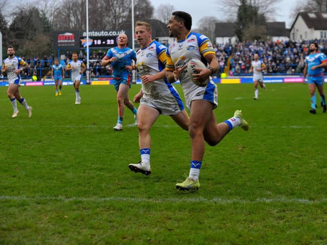 Derrell Olpherts scores for Rhinos in their pre-season win against Wakefield Trinity. Picture by Steve Riding.