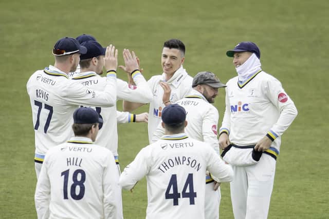 Matty Fisher receives the congratulations of his Yorkshire team-mates after dismissing Derbyshire's Harry Came. Picture by Allan McKenzie/SWpix.com