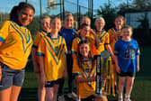 Inspired: The girls of Hunslet ARLFC with the Grand Final trophy brought in by York Valkyrie captain Sinead Peach.