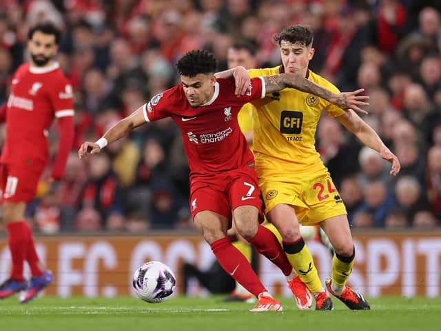 Sheffield United's Ollie Arblaster battles with Liverpool rival Luis Díaz during the Premier League match at Anfield. Photo by Jan Kruger/Getty Images.