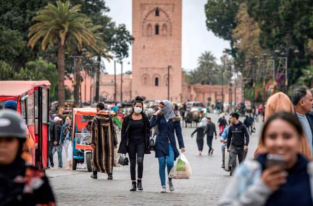 Moroccans walk through Djemaa el-Fnaa, Marrakerch (Getty Images)