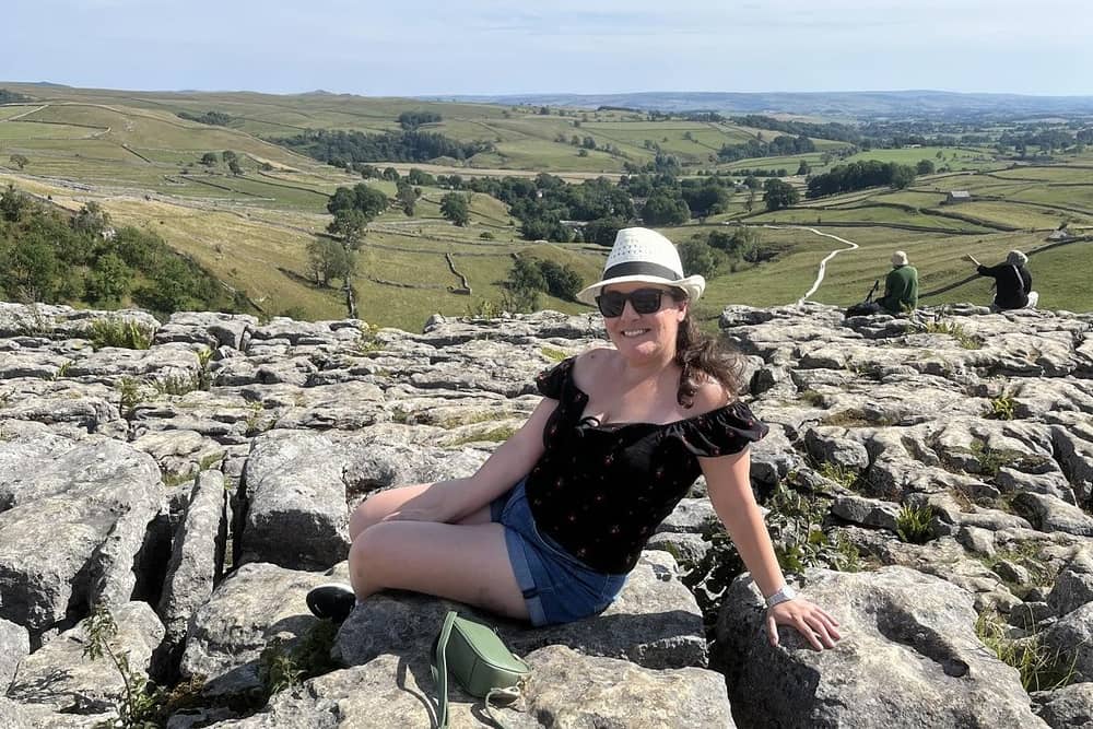 Liana sitting on one of the limestones at Malham Cove.