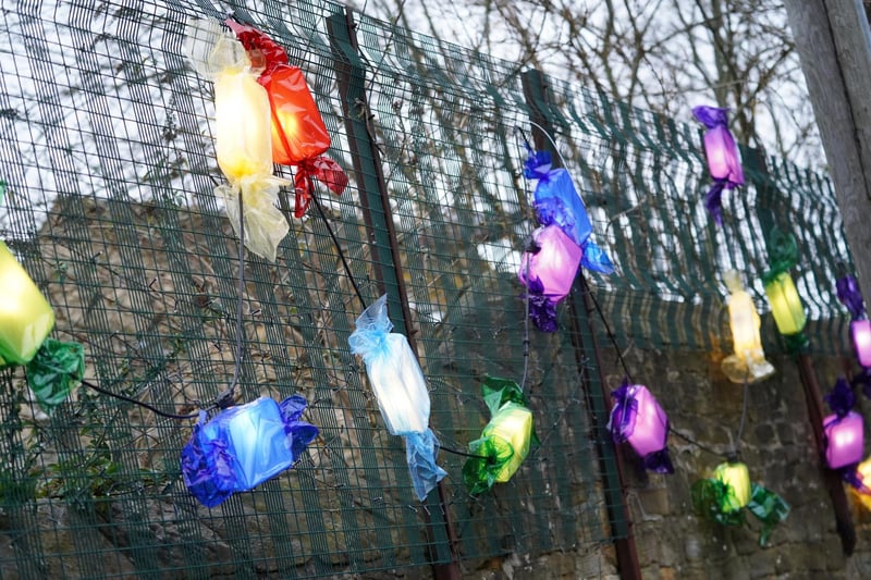 'Quality Street' decorations on a fence.