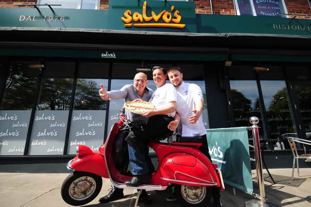 John, left, celebrates the serving of Salvo's one millionth pizza in 2017