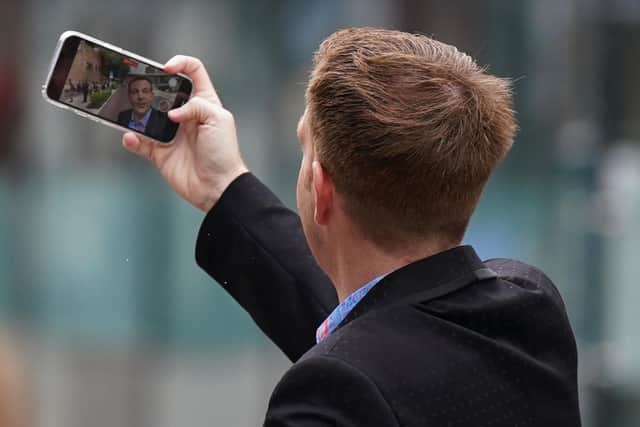 Ex-BBC presenter Alex Belfield on his phone outside court during his trial in Nottingham.