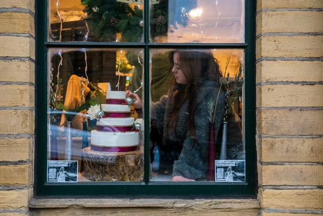 Floristry students from Shipley College in the three windows at Mill Building , Victoria Road, Saltaire, Bradford. Pictured Izzy Spilsbury, working on her display.
