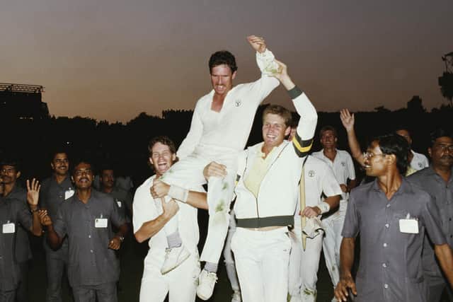 Australia captain Allan Border is hoisted high by team-mates Dean Jones, left, and Tom Moody, as local security officials look on. Photo by Allsport/Getty Images/Hulton Archive.
