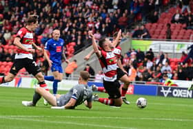 Picture Howard Roe/AHPIX LTD, Football, Sky Bet League Two,Doncaster Rovers v Harrogate Town ,Eco Power Stadium, Doncaster, UK,03/8/2023, K.O 3.00pmDoncaster Rovers' Tommy Rowe is brought down by  Mark Oxley 