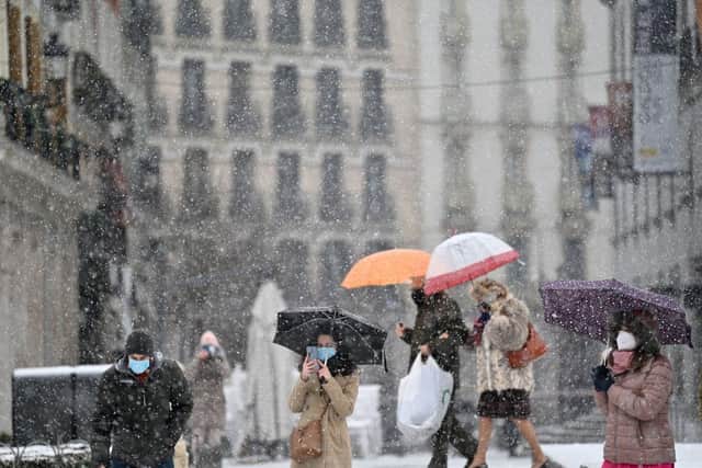 People walk in the snow in Madrid as storm Filomena affects parts of Spain (Getty Images)