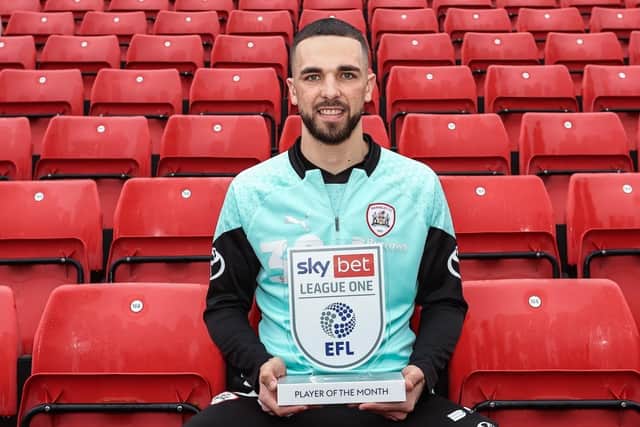 Barnsley's Adam Phillips, with his EFL Sky Bet League One player of the month award for February. Picture courtesy of Barnsley FC.