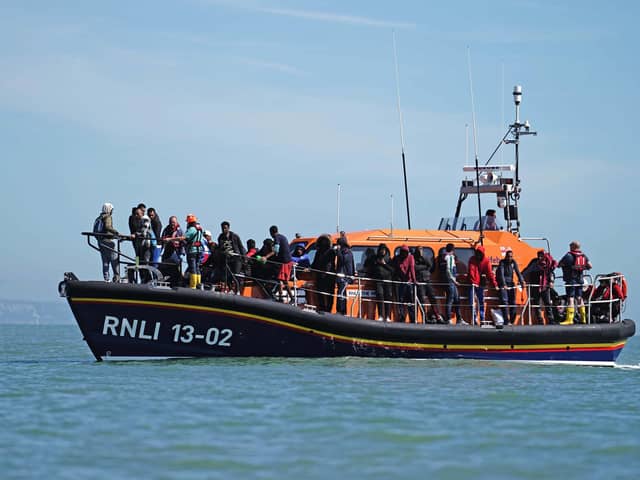 A group of people thought to be migrants are brought in to Dungeness, Kent, onboard an RNLI Dungeness Lifeboat, following a small boat incident in the Channel. PIC: Jordan Pettitt/PA Wire