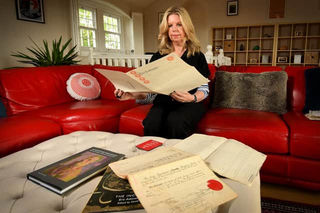 Vivien Strachan pictured with the title deeds in her home on Lombard Street, Rawdon, Leeds