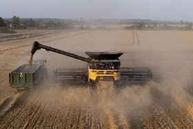 A combine harvester cuts corn in the evening sunshine on the Romney Marsh in Kent. The UK will enter its third heatwave in as many months this week - although temperatures are not expected to soar into record-breaking territory.  Gareth Fuller/PA Wire