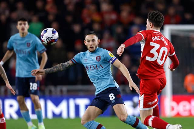 BIG NIGHT: Burnley's Josh Brownhill (left) and Middlesbrough's Hayden Hackney battle for the ball at the Riverside Stadium  Picture: Richard Sellers/PA