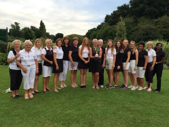 Huddersfield ladies captain Liz Roberts holds the trophy after the side's third win in a row in the YLCGA scratch team finals, staged at Fulford.