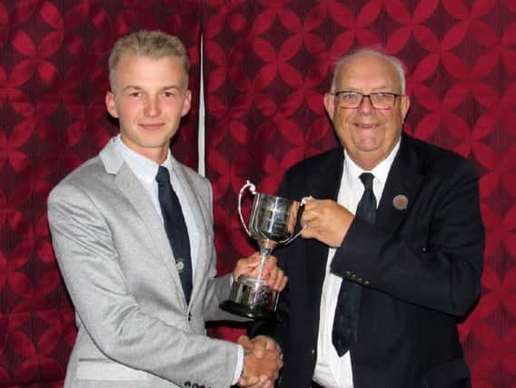 Charlie Thornton receives the England Golf Boys Order of Merit trophy from Anthony Abraham, Yorkshire Union of Golf Clubs' chairman of selectors.