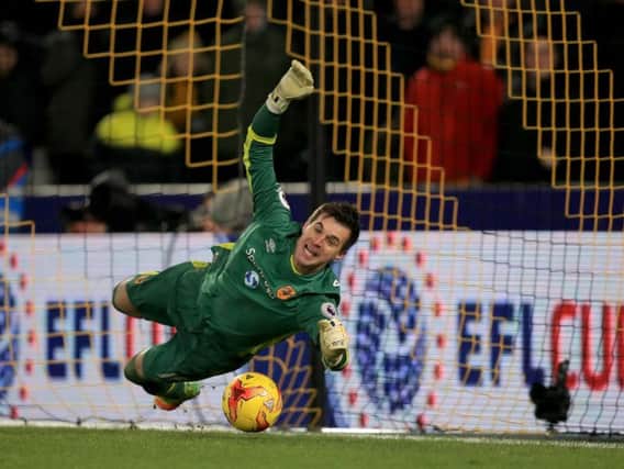 Eldin Jakupovic makes one of his three saves in the shoot-out (Photo: PA)