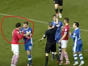 The referee shows Sam Hutchinson the red card before ushering Adam Hammill off the field