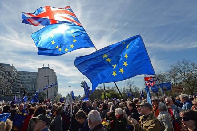 Placards and flags are held by pro-EU protesters taking part in a March for Europe rally against Brexit in central London.