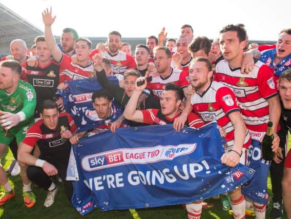 We are going up! The Doncaster Rovers squad celebrate winning promotion at full-time