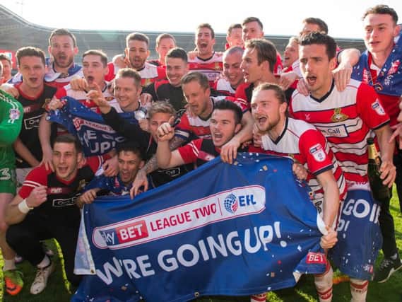 The Doncaster squad celebrate on the pitch at full-time (Photo: PA)
