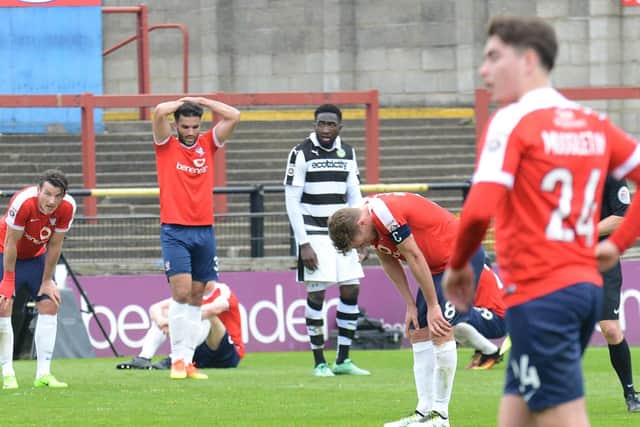 York City's squad slump to the floor after their relegation on the final day of the season