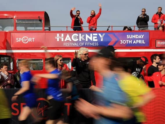 Sir Richard Branson (centre) waves off runners after starting the half marathon at the launch of Virgin Sport Hackney at the Hackney Marshes Centre, London. (Photo: Gareth Fuller/PA Wire)